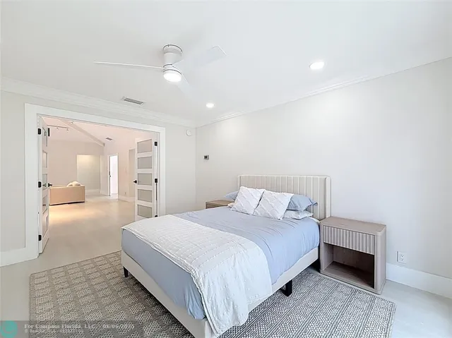 a bedroom with a large bed and a large window