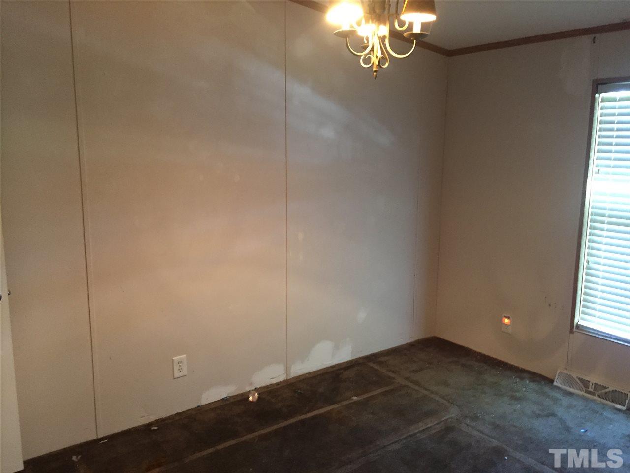 16 Trevor Kirk Road Timberlake, NC 27583 - Photo 12 of 12 en empty room with windows and chandelier fan