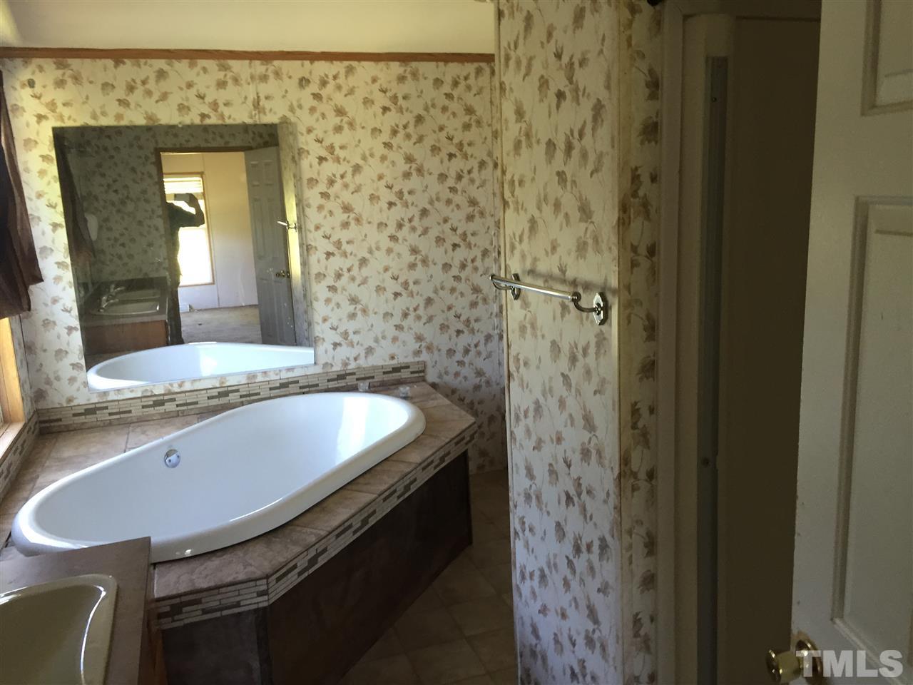 16 Trevor Kirk Road Timberlake, NC 27583 - Photo 3 of 12 a bathroom with a sink and a mirror