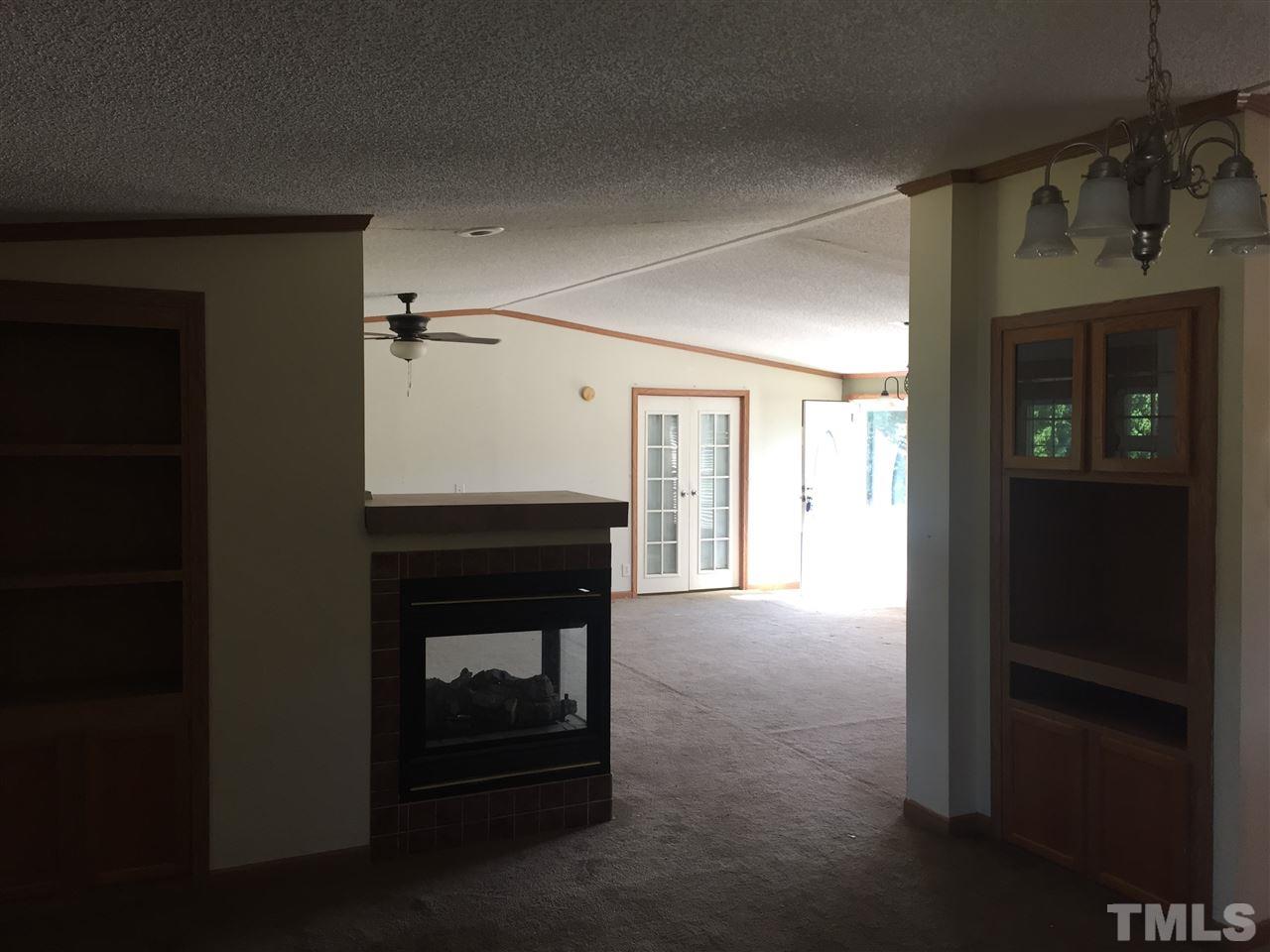 16 Trevor Kirk Road Timberlake, NC 27583 - Photo 6 of 12 a view of an empty room with a fireplace