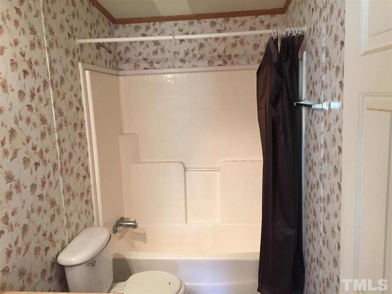 16 Trevor Kirk Road Timberlake, NC 27583 - Photo 10 of 12 a bathroom with a shower toilet and sink