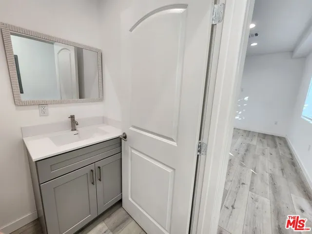 a bathroom with a sink a mirror and a shower