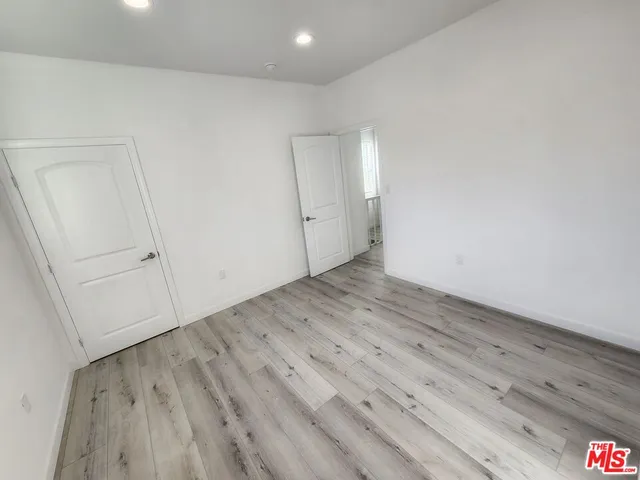 a view of a room with wooden floor