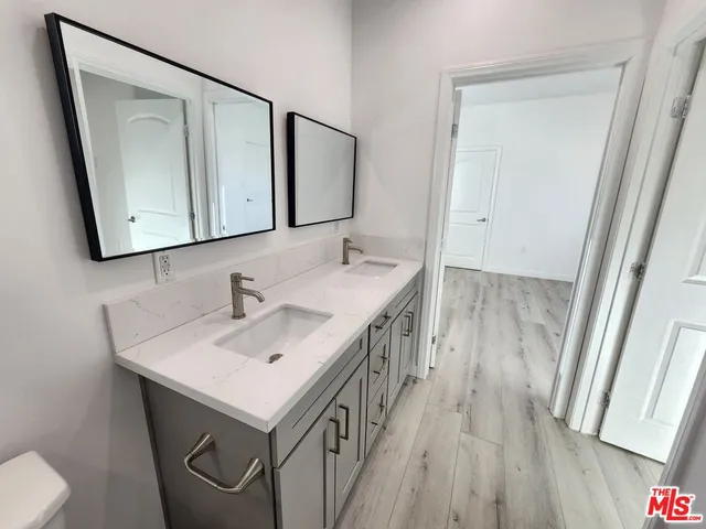 a bathroom with 2 sink and a mirror