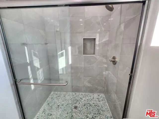 a bathroom with a toilet sink double vanity and mirror