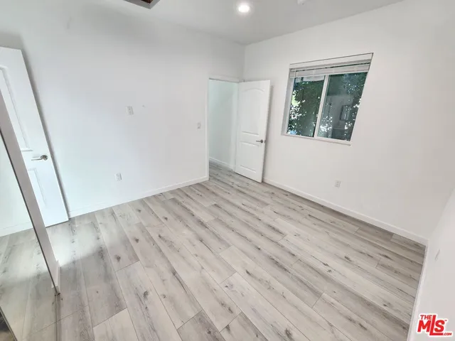 a view of hallway with wooden floor