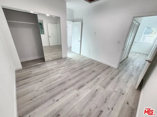 a view of hallway with wooden floor