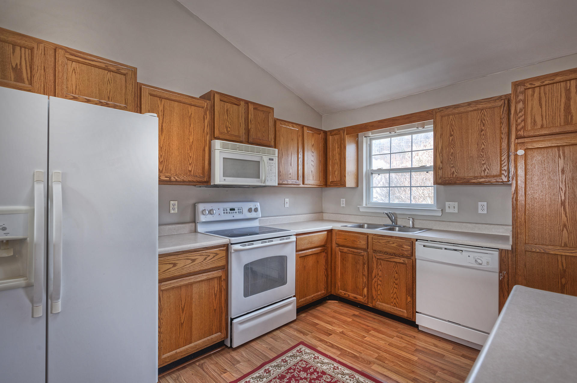 4754 West Westvale Road Northeast Roanoke, VA 24019 - Photo 4 of 22 a kitchen with stainless steel appliances granite countertop a sink a stove a refrigerator and cabinets