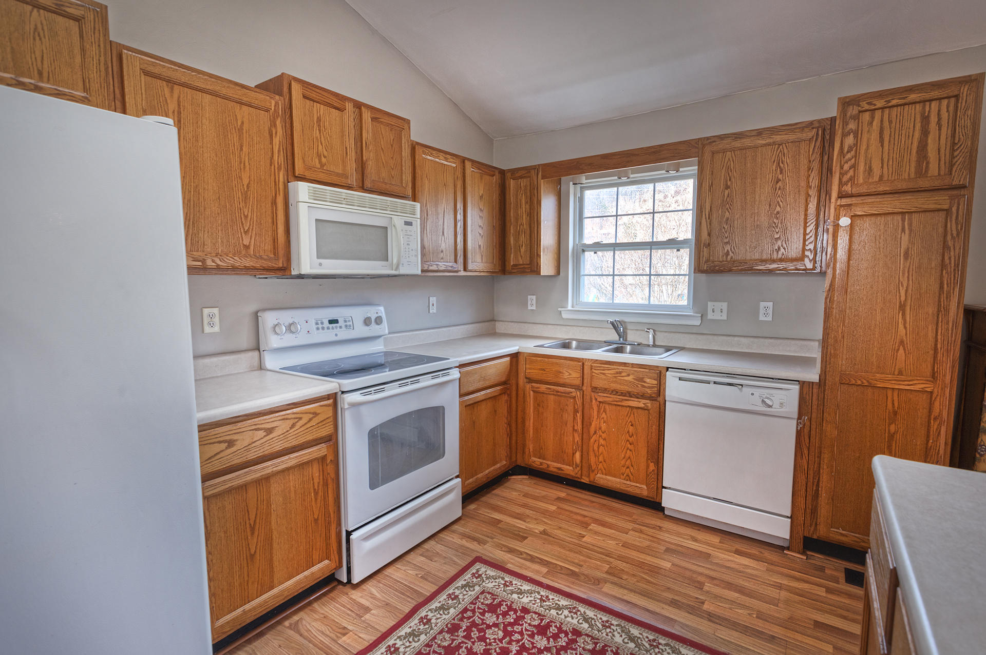 4754 West Westvale Road Northeast Roanoke, VA 24019 - Photo 5 of 22 a kitchen with a sink cabinets stainless steel appliances and a window
