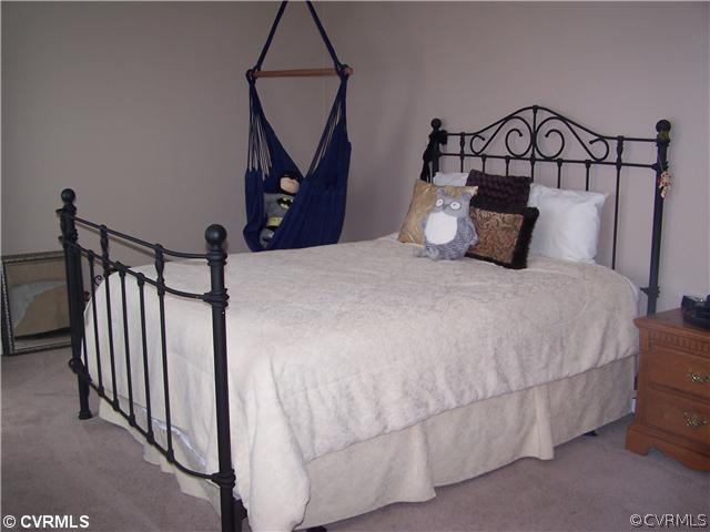 14801 River Road Chesterfield, VA 23838 - Photo 9 of 12 a bedroom with a bed and a wooden floor