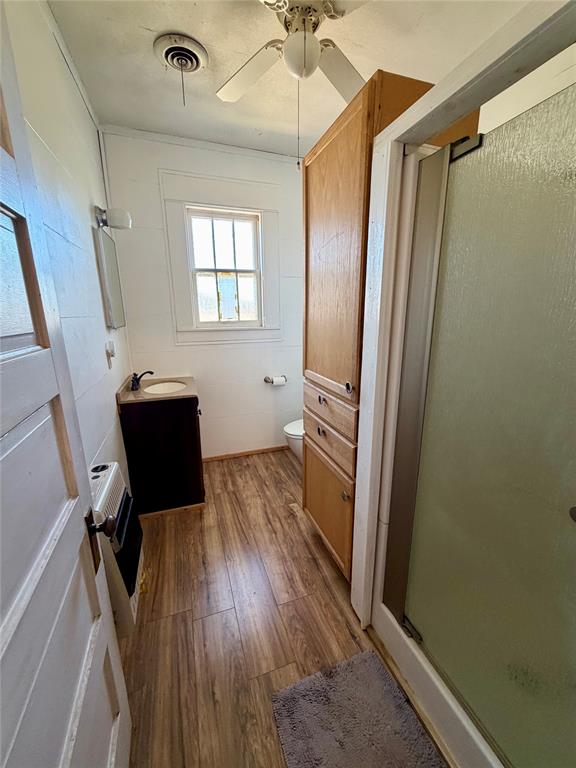 600 Mercer Street Quanah, TX 79252 - Photo 22 of 28 a view of a hallway with wooden floor and staircase
