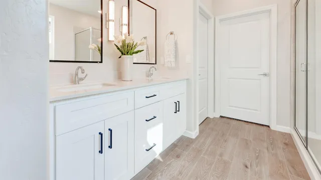a bathroom with a double vanity sink and mirror