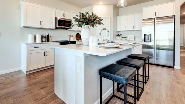 a kitchen with stainless steel appliances a sink stove and refrigerator