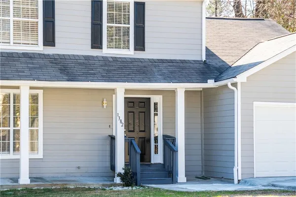 a front view of a house with garden
