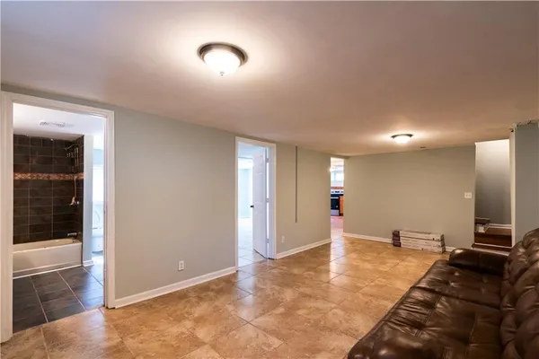 a bathroom with a toilet a sink a mirror and a shower