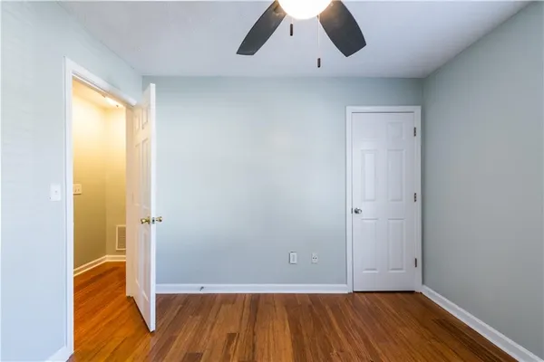 a kitchen with granite countertop a stove and white cabinets
