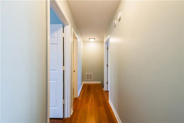 a kitchen with a refrigerator and a stove top oven