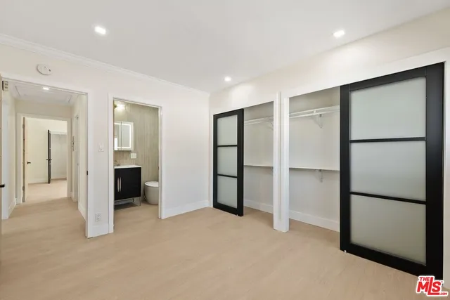 a view of an empty room with a kitchen