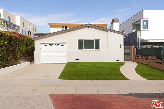 a view of a white house with a yard and garage