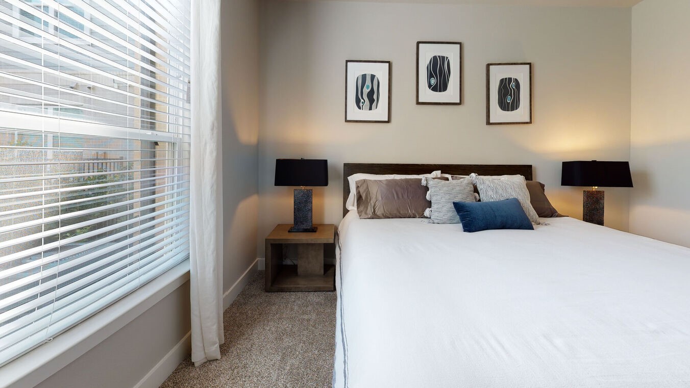 24002 Colonial Parkway, Unit 4215 Katy, TX 77493 - Photo 13 of 31 a bed room with a bed and paintings on the wall