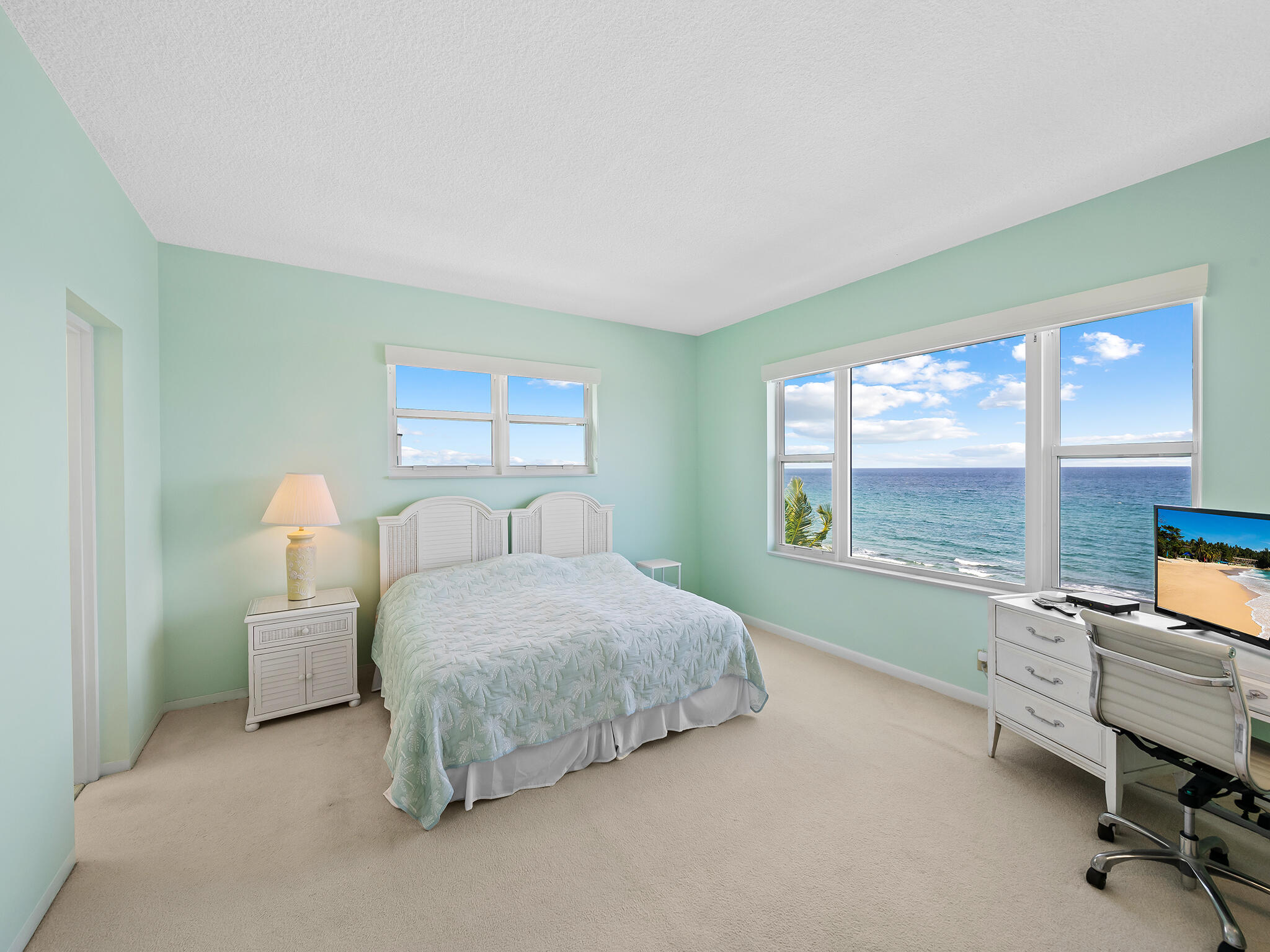 2921 South Ocean Boulevard, Unit 507 Highland Beach, FL 33487 - Photo 13 of 22 a bedroom with a bed and large windows