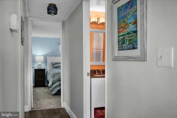 a view of a hallway with a closet and a window