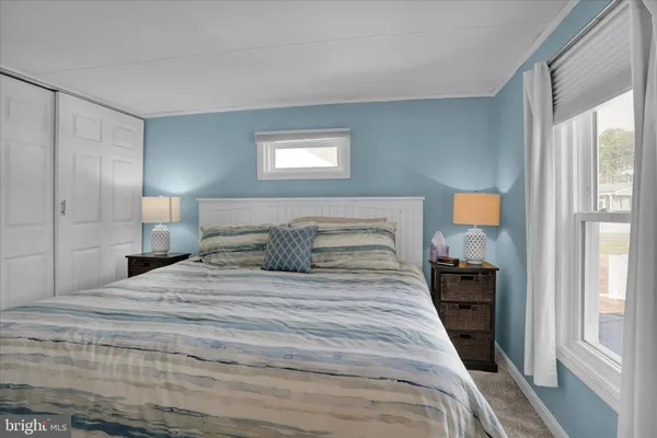 a bedroom with a large bed and a window