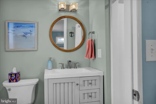 a bathroom with a toilet a sink and a mirror