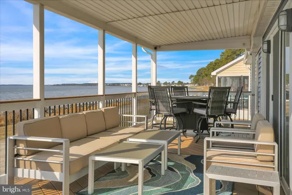 a outdoor space with patio the couches and kitchen view with wooden floor