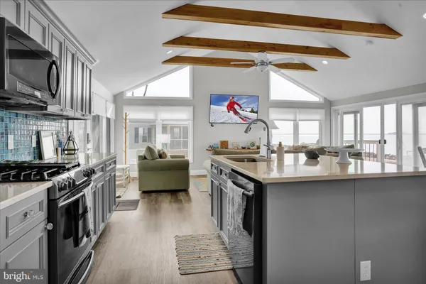 a kitchen with stainless steel appliances granite countertop a sink and a stove