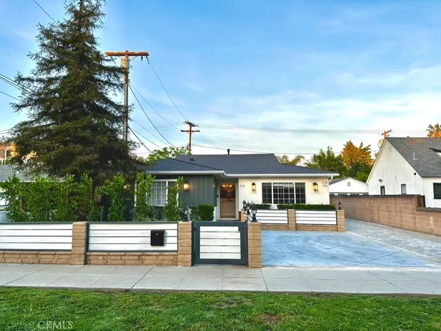 a view of house with outdoor seating and yard
