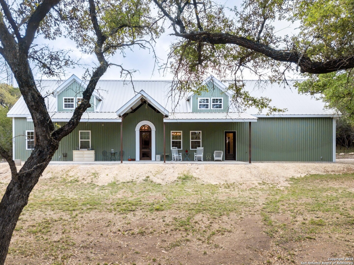 792 Alamo Beach Road Pipe Creek, TX 78063 - Photo 1 of 70 a front view of a house with a yard and garage