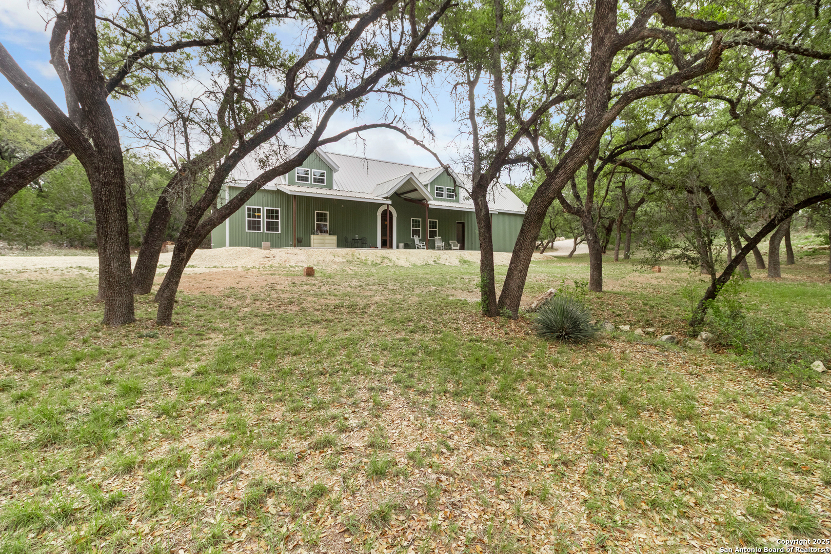 792 Alamo Beach Road Pipe Creek, TX 78063 - Photo 31 of 70 a front view of a house with a yard