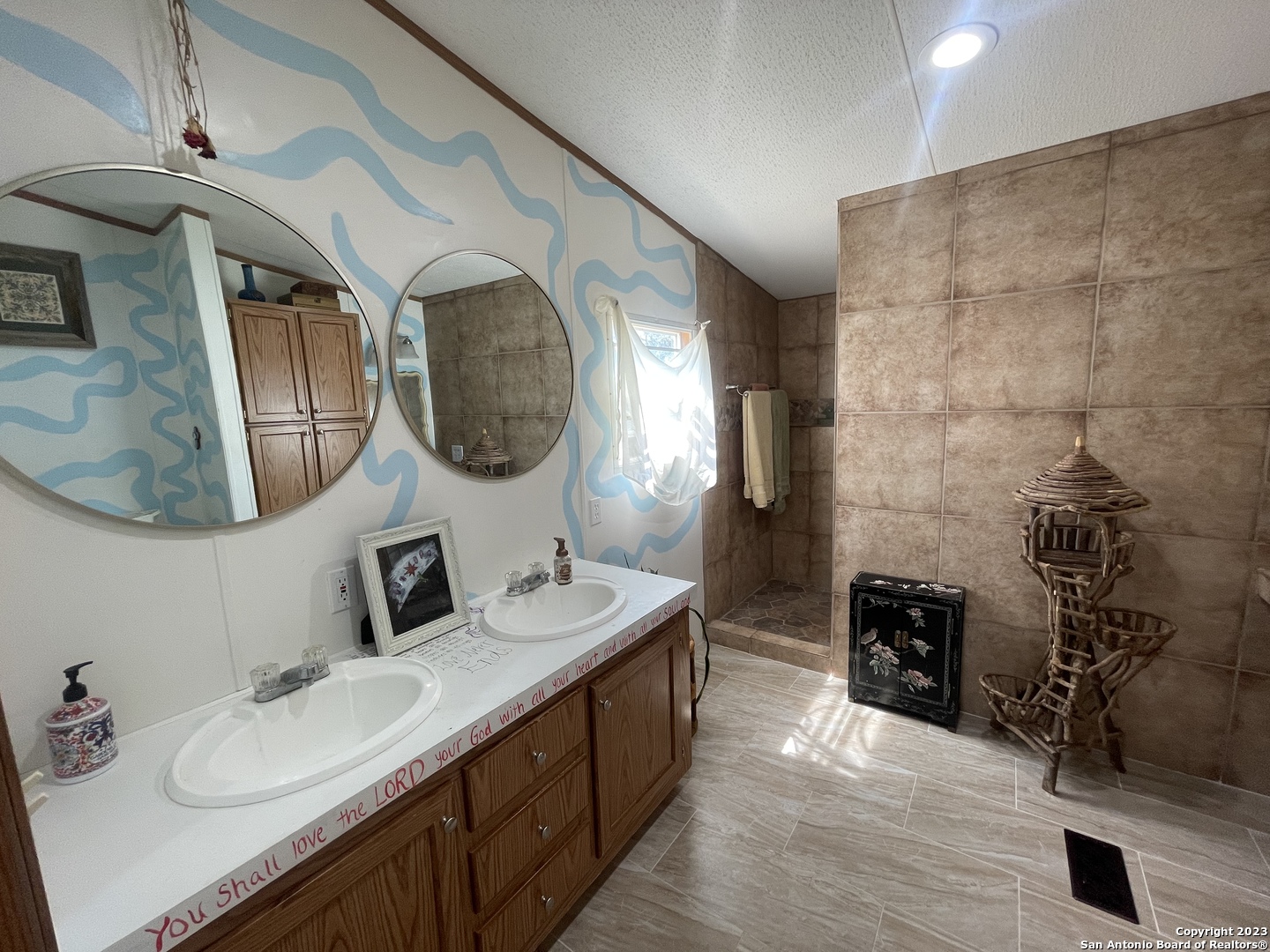 792 Alamo Beach Road Pipe Creek, TX 78063 - Photo 55 of 70 a bathroom with double vanity and a mirror