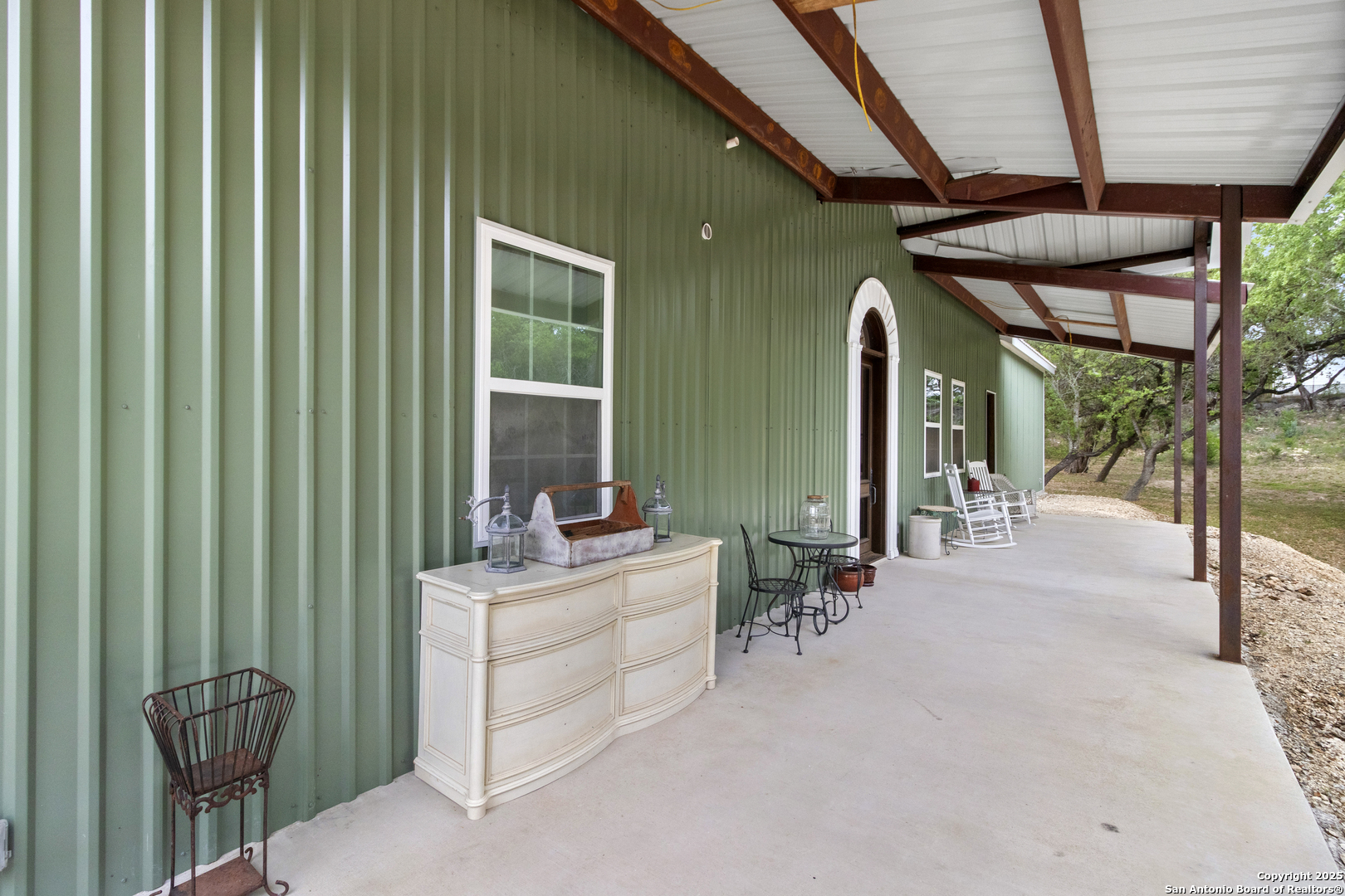 792 Alamo Beach Road Pipe Creek, TX 78063 - Photo 62 of 70 a view of a porch with chairs and backyard