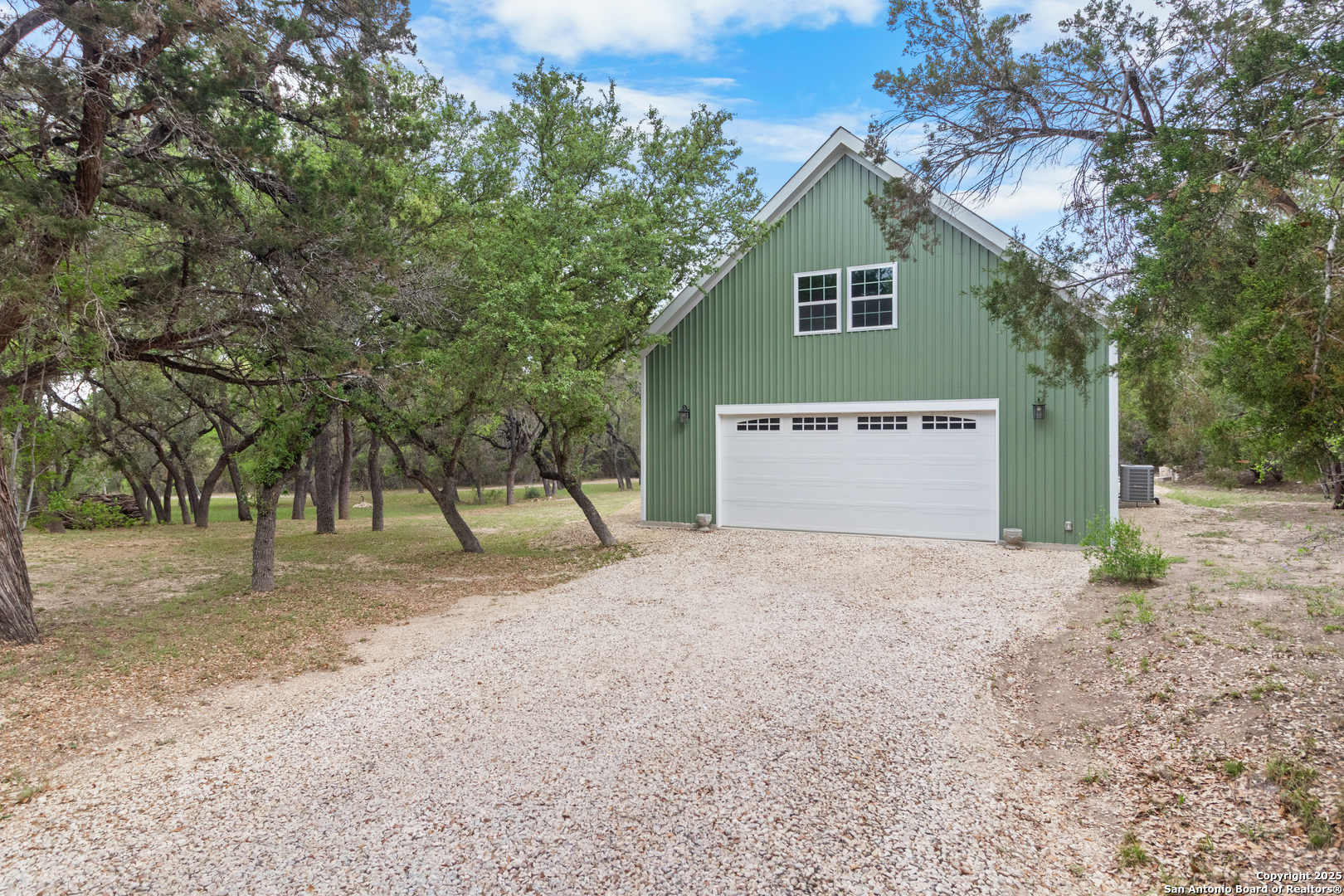 792 Alamo Beach Road Pipe Creek, TX 78063 - Photo 64 of 70 a front view of a house with a yard and garage