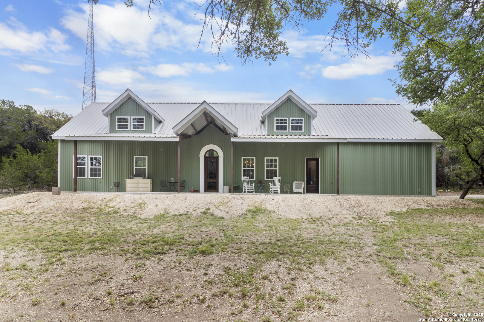 792 Alamo Beach Road Pipe Creek, TX 78063 - Photo 66 of 70 a front view of a house with a yard and garage