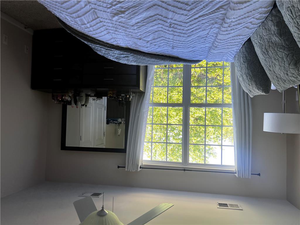 8549 Gateway Road Breinigsville, PA 18031 - Photo 19 of 26 A tranquil bedroom features a generous window overlooking lush greenery, perfect for serene mornings.