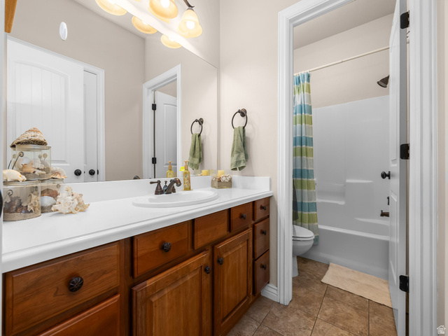 255 East 1200 North Mapleton, UT 84664 - Photo 24 of 37 Bathroom vanity featuring a single basin sink, white countertop, and wood-finish cabinetry with dark hardware