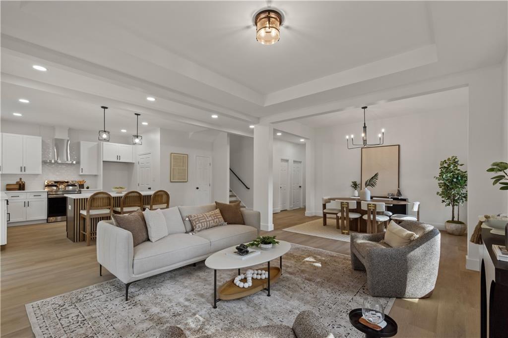 a living room with furniture and a chandelier