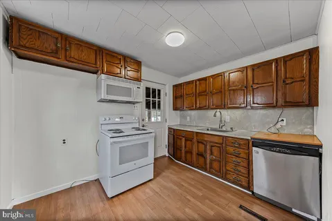 a kitchen with stainless steel appliances granite countertop a stove and a sink
