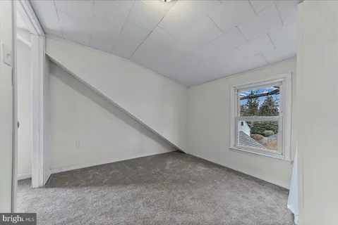 a view of an empty room with windows