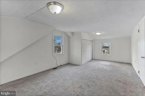 an empty room with a empty space and windows