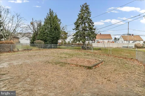 a backyard of a house with a yard and outdoor seating