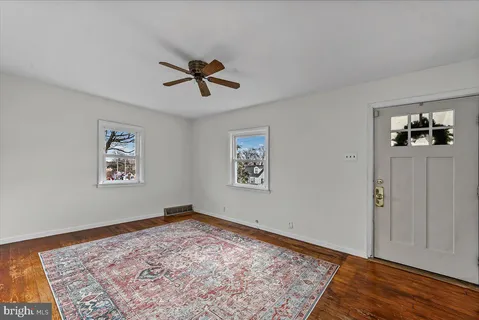 a view of a hallway with wooden floor and closet