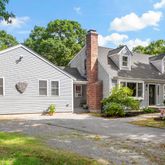 a view of a house with backyard and a garden