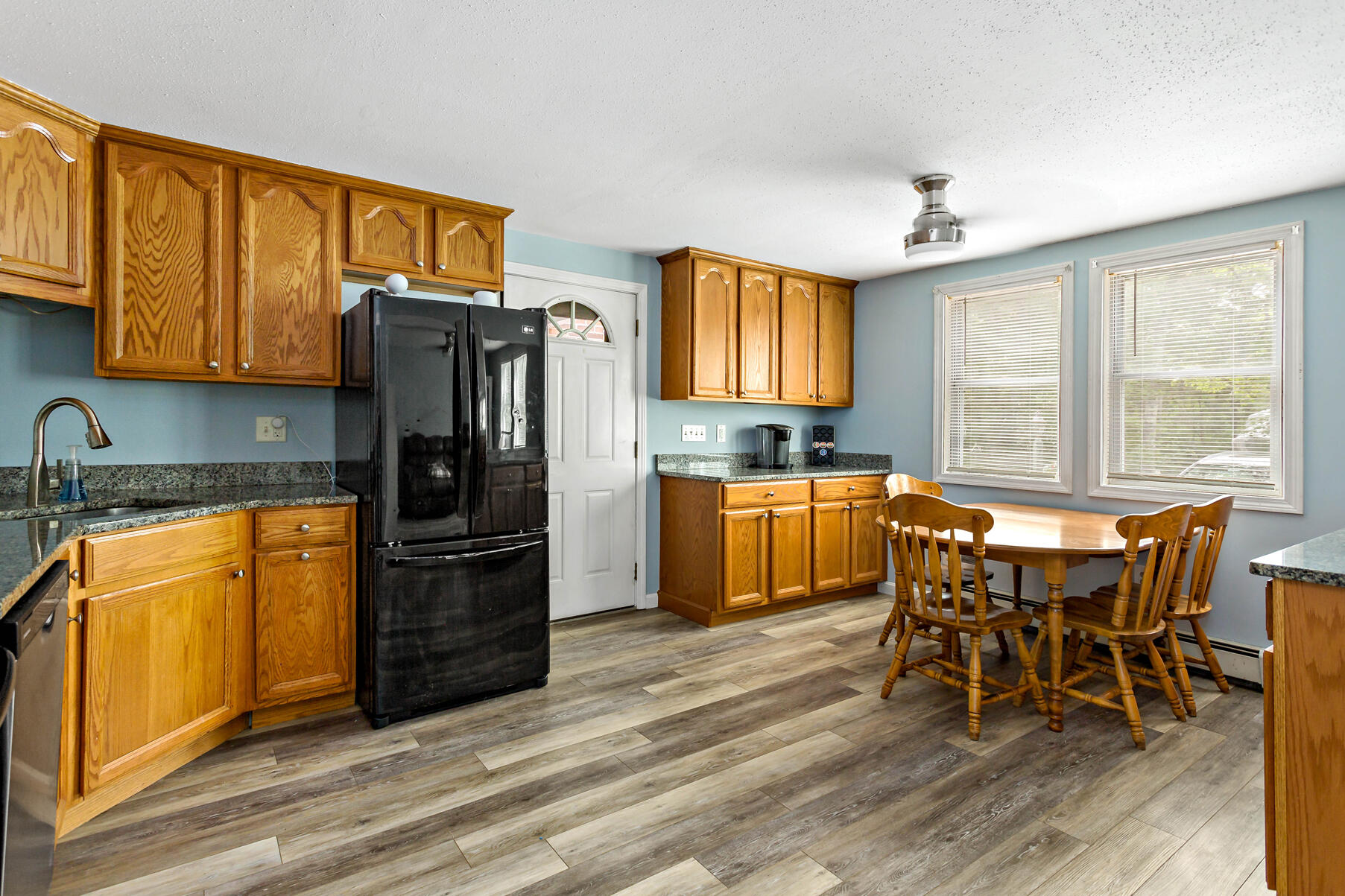 58 Saddleback Road Mashpee, MA 02649 - Photo 24 of 40 a kitchen with stainless steel appliances granite countertop a refrigerator and wooden cabinets