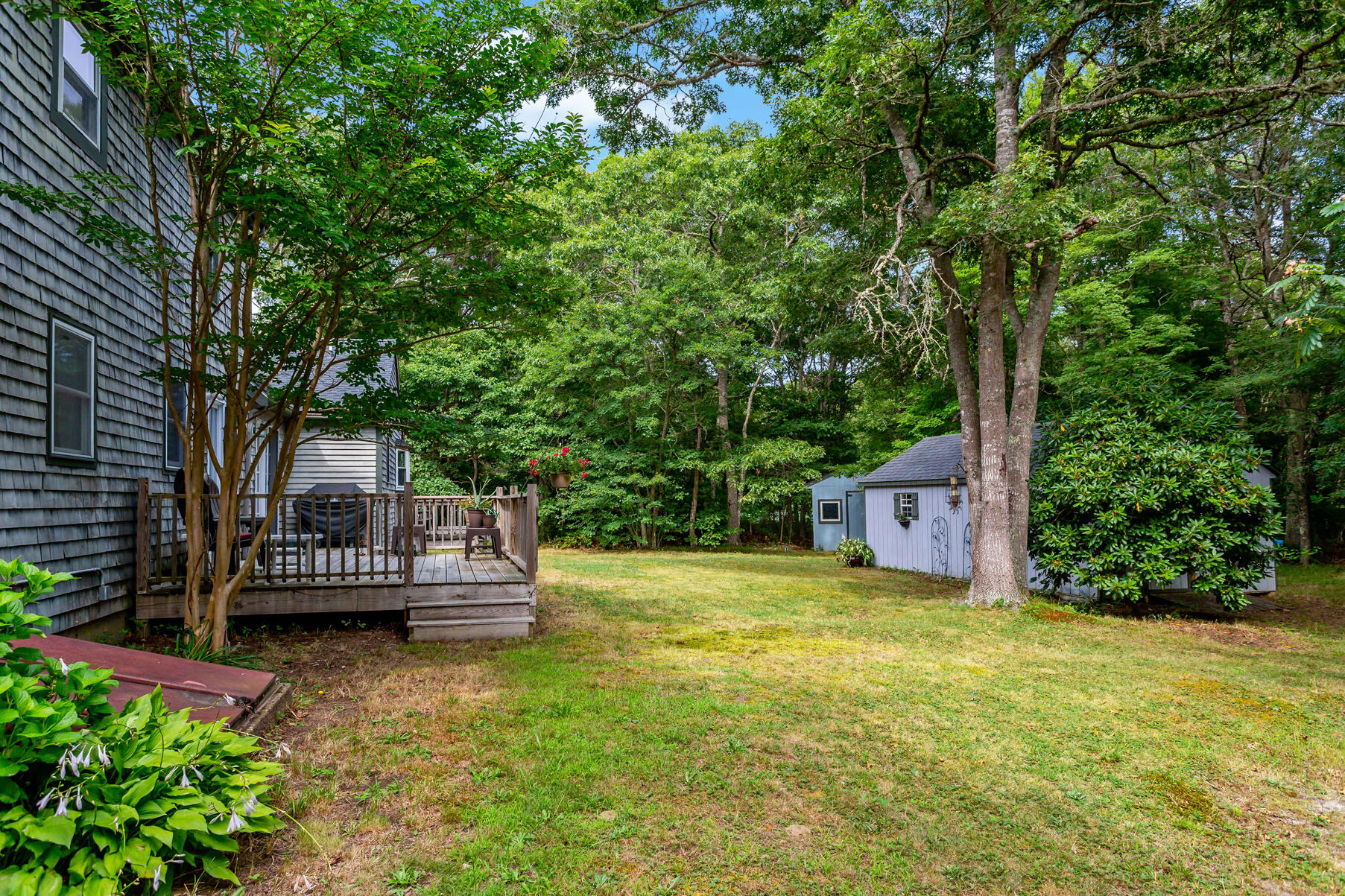 58 Saddleback Road Mashpee, MA 02649 - Photo 29 of 40 a front view of a house with a garden and yard