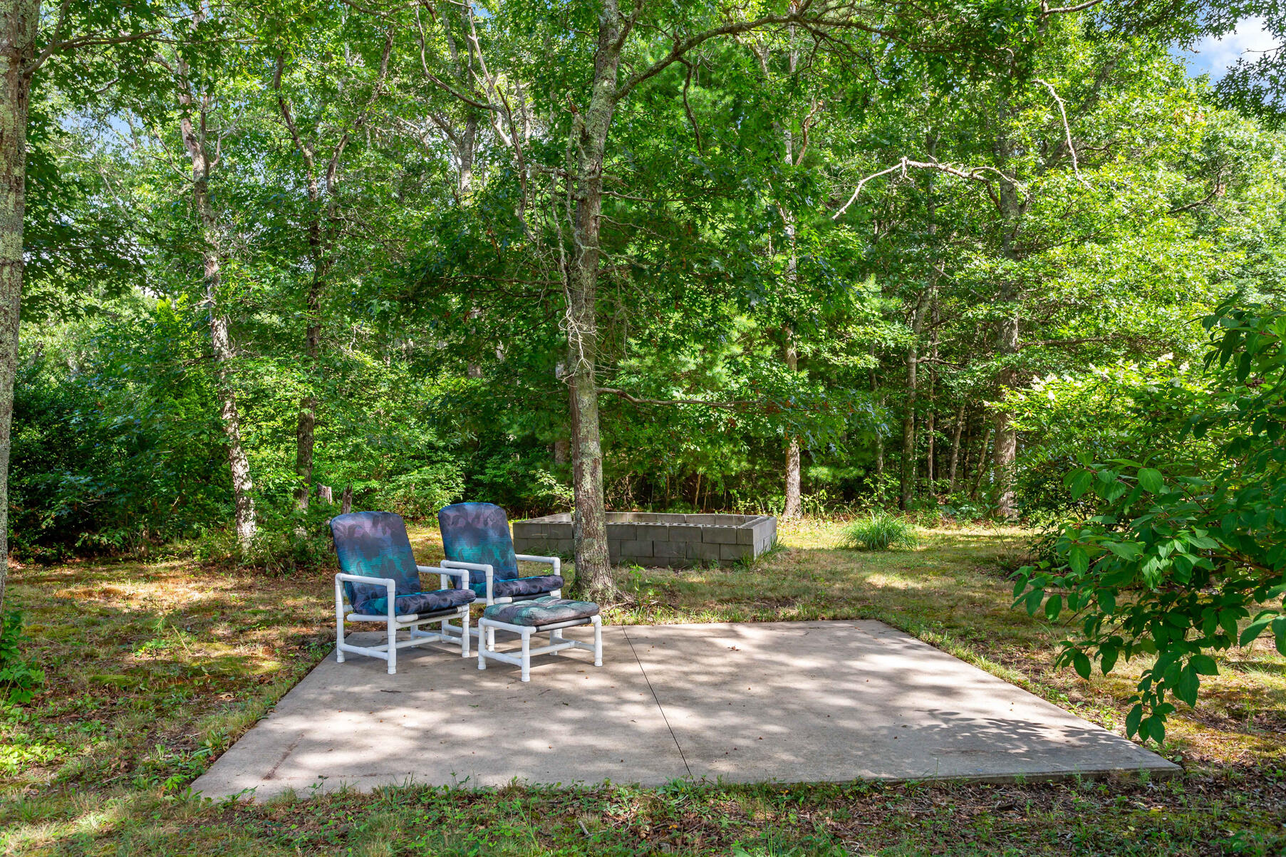 58 Saddleback Road Mashpee, MA 02649 - Photo 30 of 40 a view of a backyard with sitting area