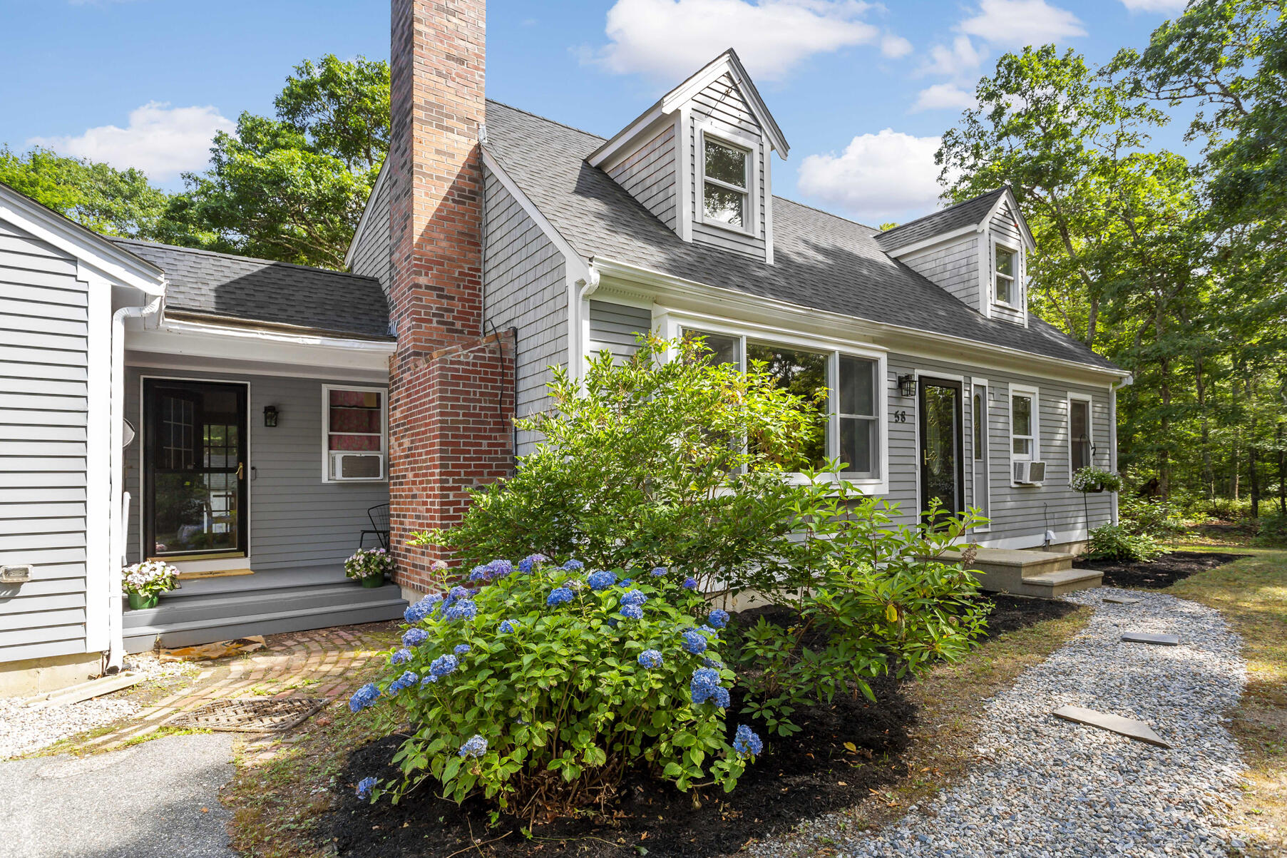 58 Saddleback Road Mashpee, MA 02649 - Photo 3 of 40 a front view of a house with garden